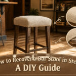 A bar stool with its seat removed, showing the base and old upholstery.
