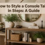 A console table styled with a mirror, lamp, and various decorative objects.